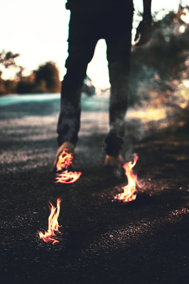 A person walks across hot coals