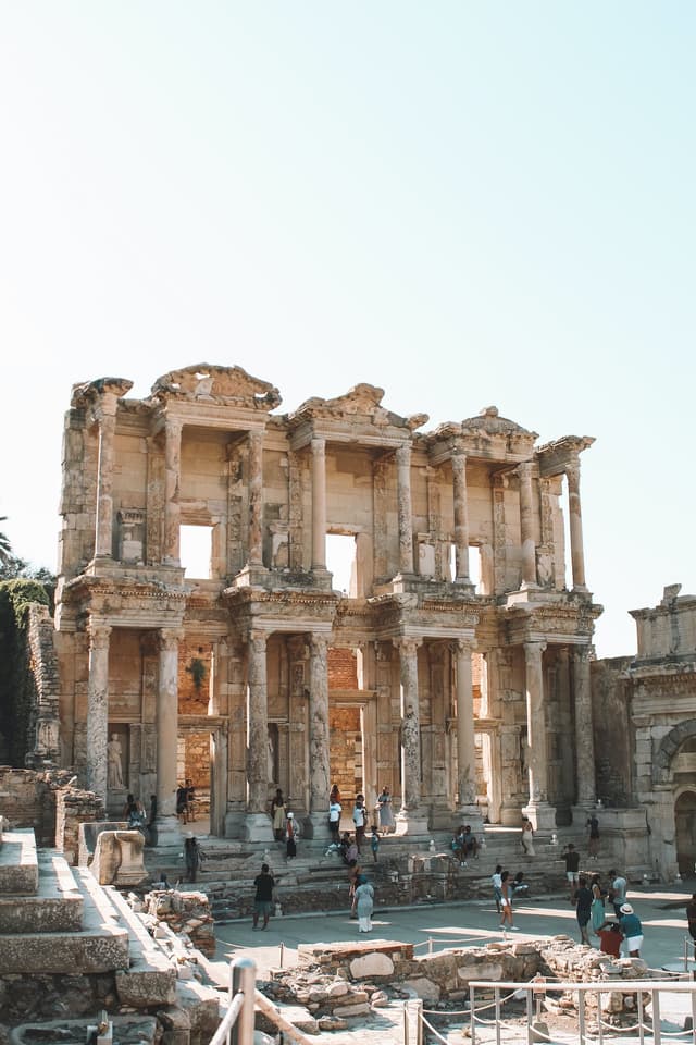 Facade of the library at Ephesus with other ruins and people around