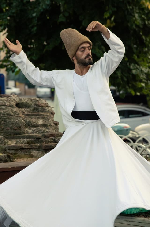 Whirling Dirvish dancing, with white skirt twirling around him